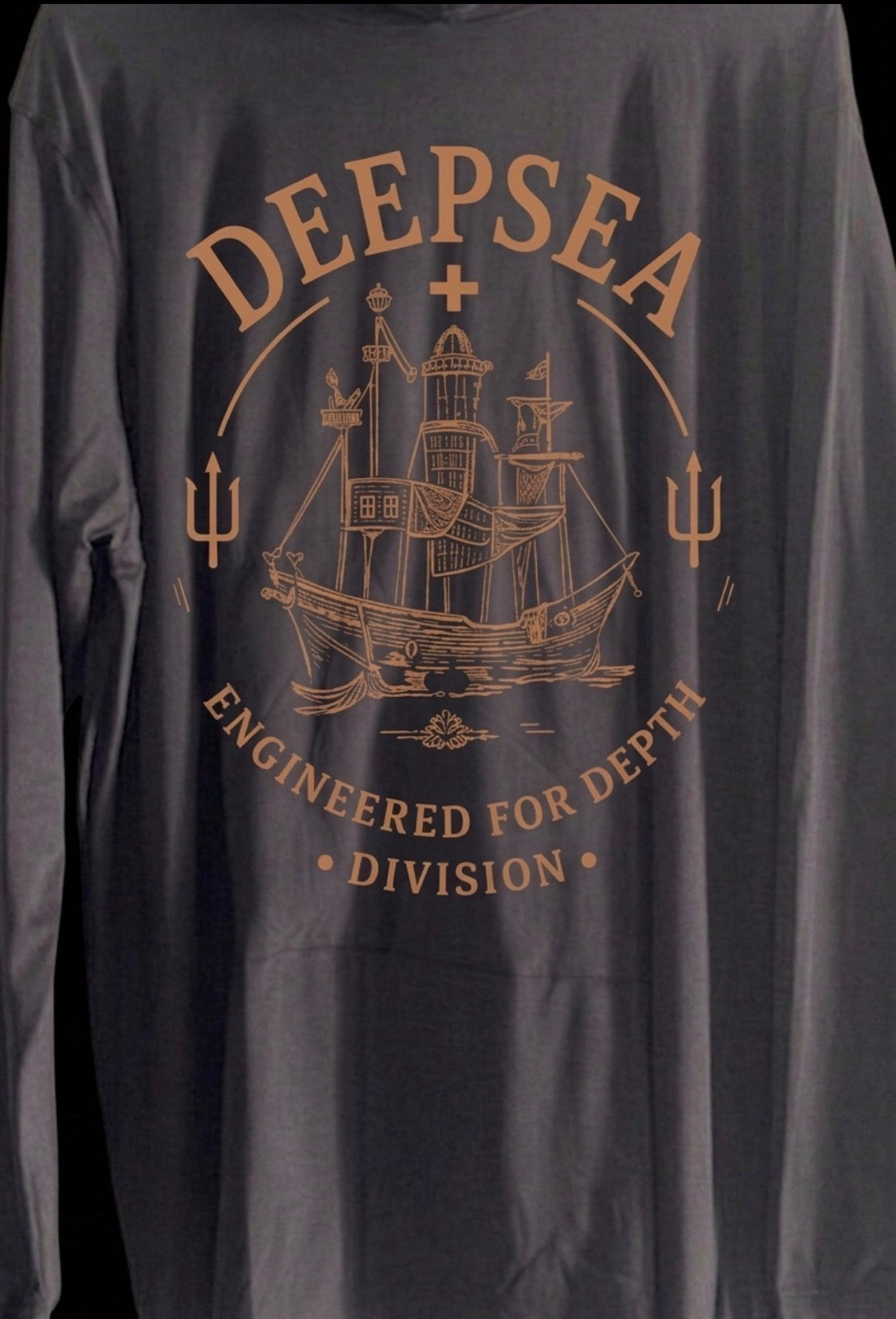 Lightweight DeepSea performance fishing hoodie featuring a built-in face mask, hood, breathable Lycra material, and relaxed fit built for all-day comfort on and off the water. With vintage logo on back